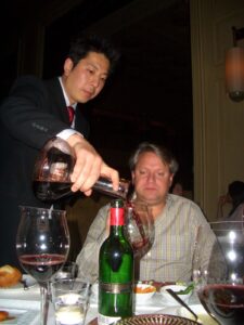 sommelier pouring red wine